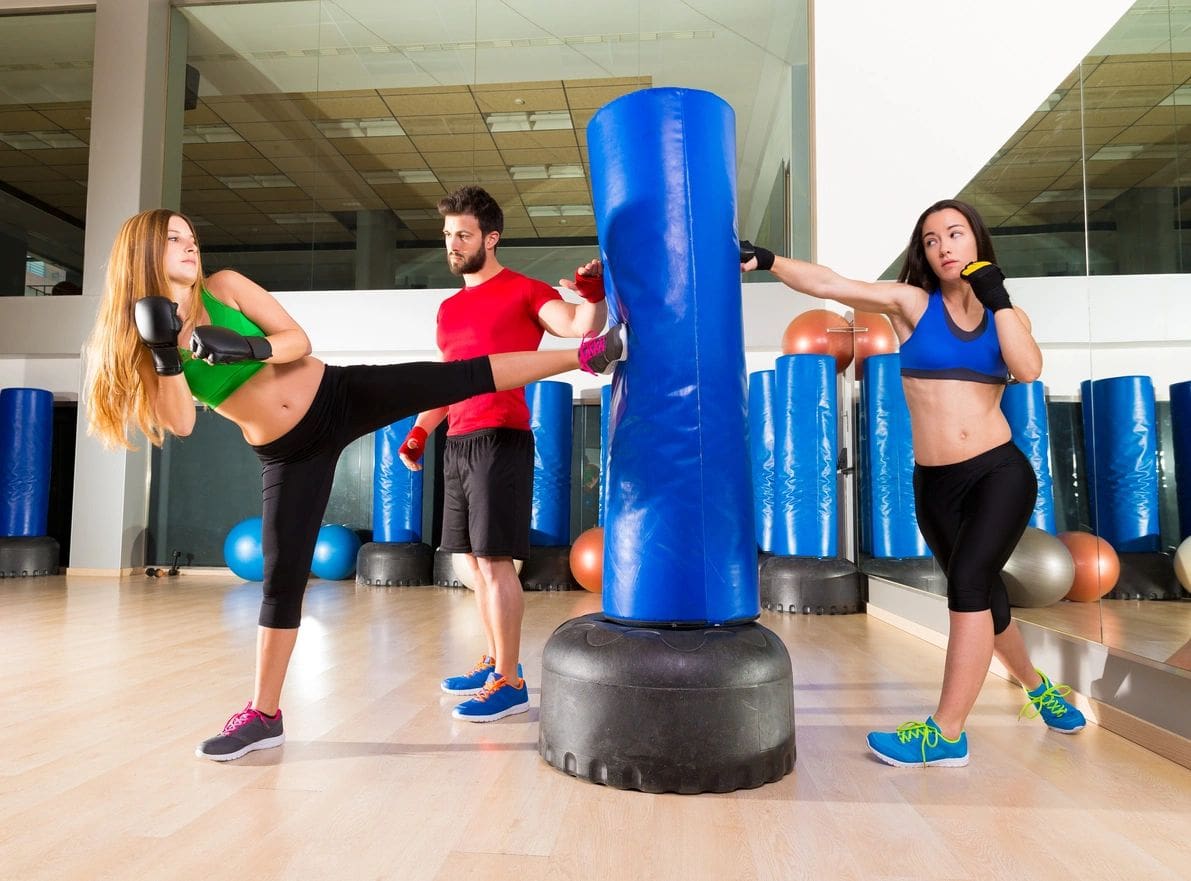 Boxing aerobox women group with personal trainer man at fitness gym Boxing aerobox women group with personal trainer man at fitness gym